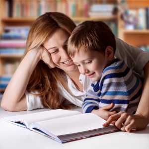 Mother reading Bible stories to her boy-178596770