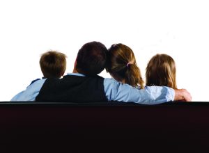 A family of four watching a blank screen